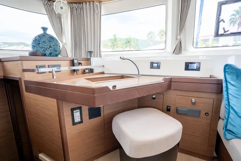 Starry Night Yacht Photos Pics Interior of 2022 Lagoon 46 yacht with modern wooden cabinetry and seating.