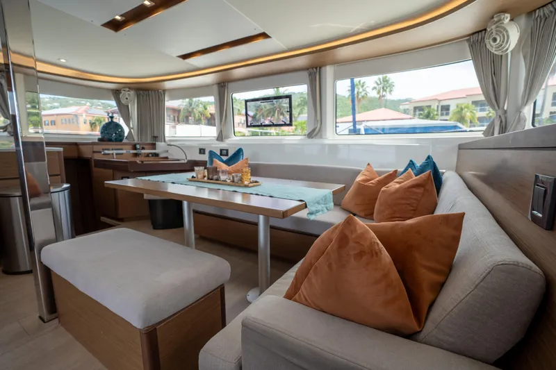 Starry Night Yacht Photos Pics Luxurious interior of 2022 Lagoon 46 yacht with elegant seating and decor.