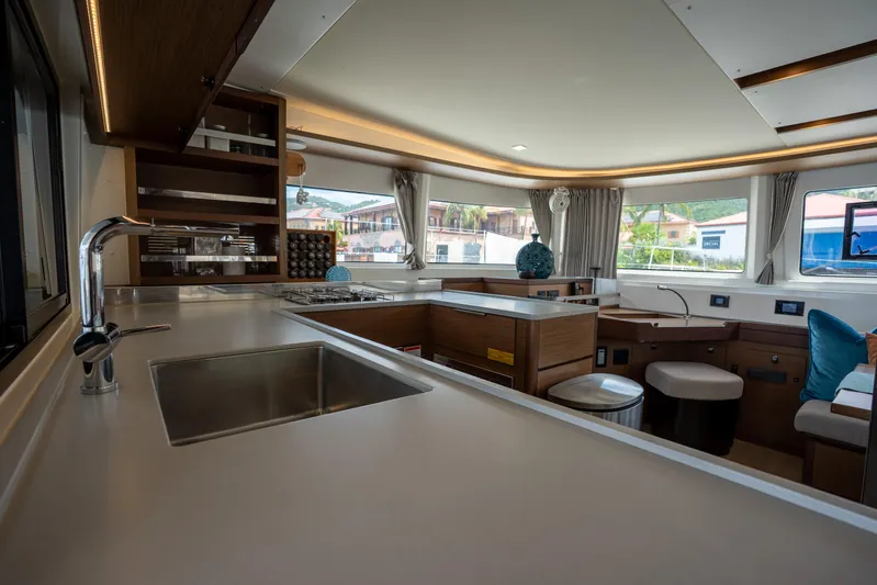 Starry Night Yacht Photos Pics Interior of 2022 Lagoon 46 yacht, featuring modern kitchen and spacious seating area.