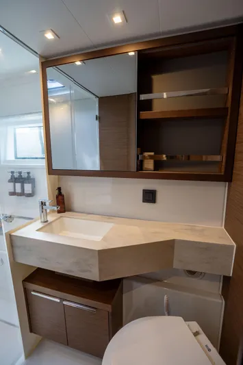 Starry Night Yacht Photos Pics Modern bathroom in 2022 Lagoon 46 yacht with sleek sink and wooden cabinetry.
