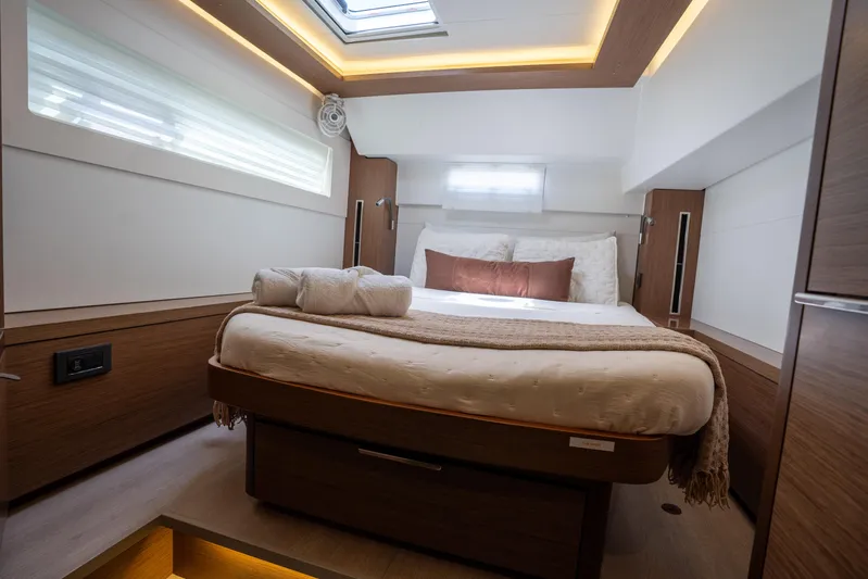 Starry Night Yacht Photos Pics Luxurious bedroom interior of 2022 Lagoon 46 yacht with modern design and ambient lighting.