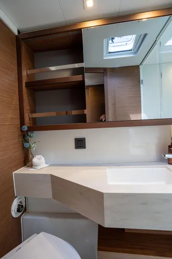 Starry Night Yacht Photos Pics Modern bathroom interior of 2022 Lagoon 46 yacht with sleek design and wooden accents.