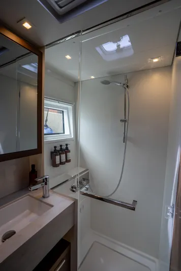 Starry Night Yacht Photos Pics Modern bathroom in 2022 Lagoon 46 yacht with sleek shower and vanity.
