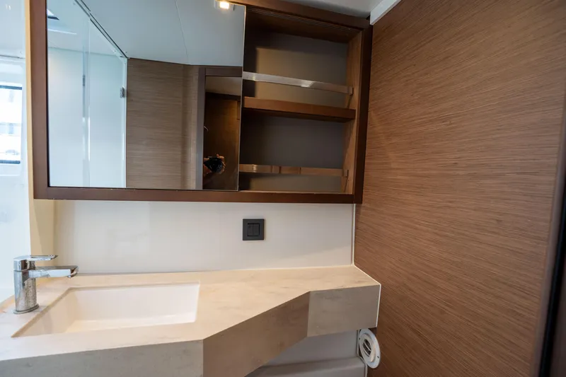 Starry Night Yacht Photos Pics Modern bathroom interior in 2022 Lagoon 46 yacht, featuring sleek sink and wooden cabinetry.