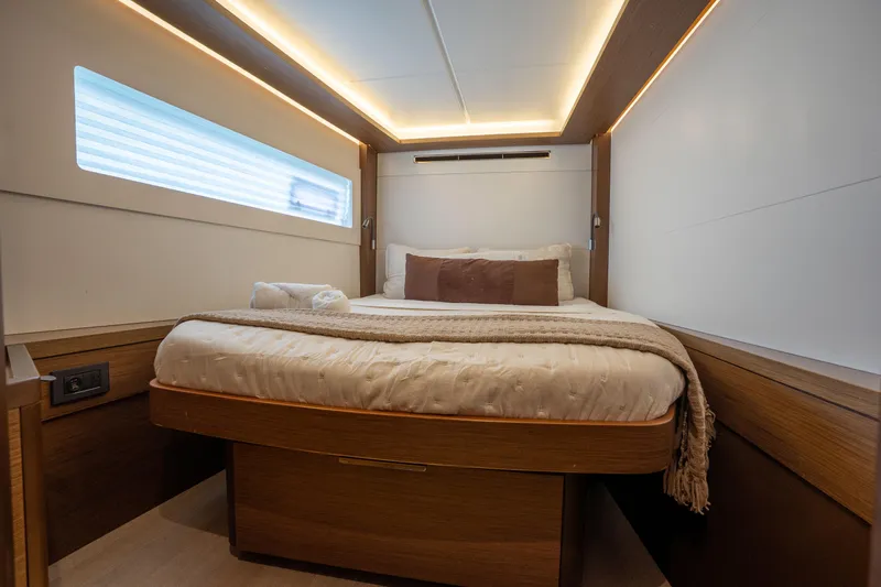 Starry Night Yacht Photos Pics Luxurious cabin interior of 2022 Lagoon 46 yacht with cozy bed and modern lighting.