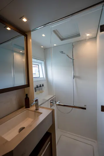 Starry Night Yacht Photos Pics Modern bathroom in 2022 Lagoon 46 yacht with sleek shower and vanity.