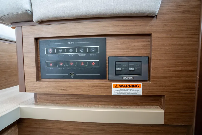 Starry Night Yacht Photos Pics Control panel on 2022 Lagoon 46 yacht with warning label and switches.
