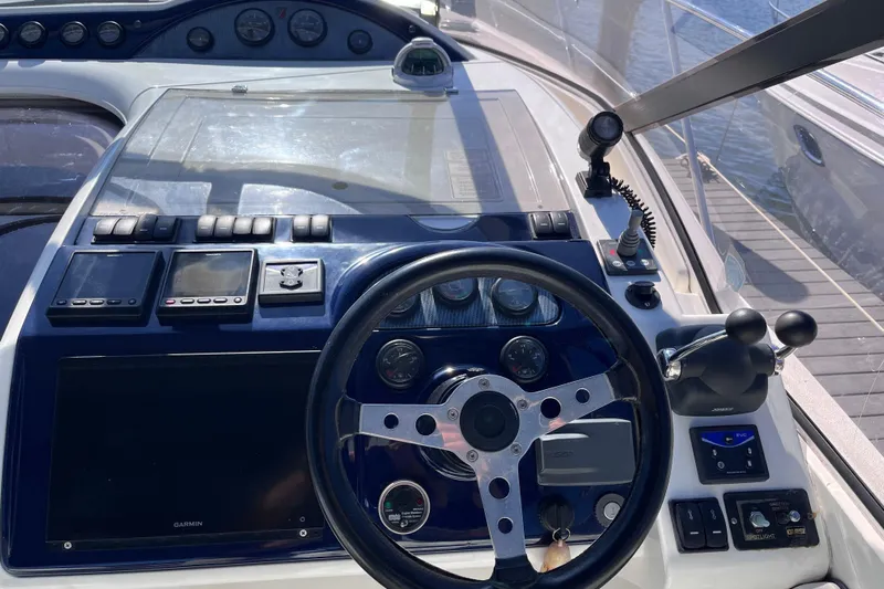  Yacht Photos Pics 2006 Fairline Targa 40 yacht helm with steering wheel and navigation controls.