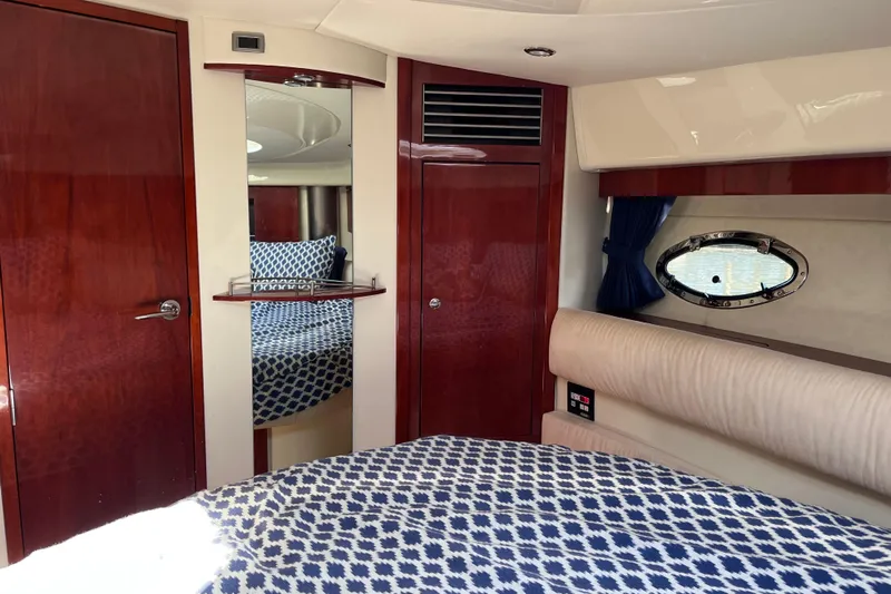  Yacht Photos Pics Interior of 2006 Fairline Targa 40 yacht with wood finish and patterned bedding.