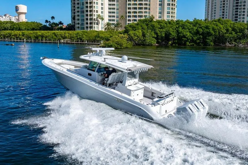  Yacht Photos Pics 2024 HCB 42 Lujo boat cruising on water near waterfront buildings.