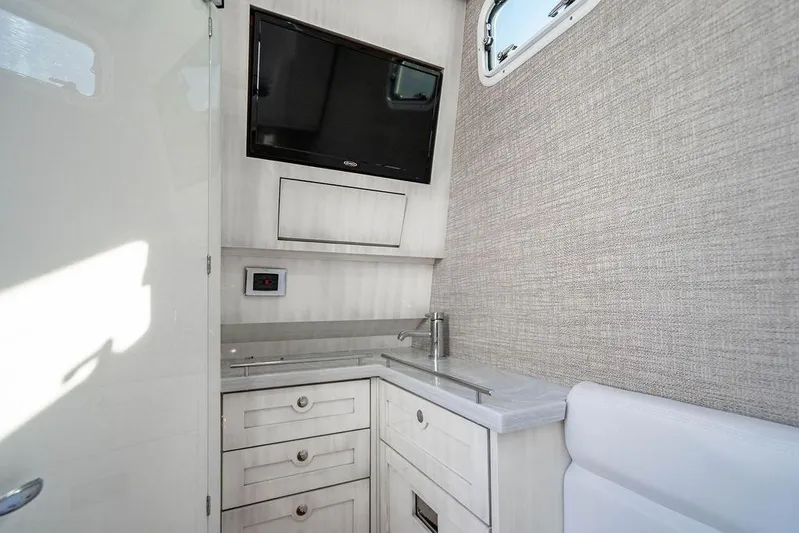  Yacht Photos Pics 2024 HCB 42 Lujo interior with TV, sink, and storage cabinets.