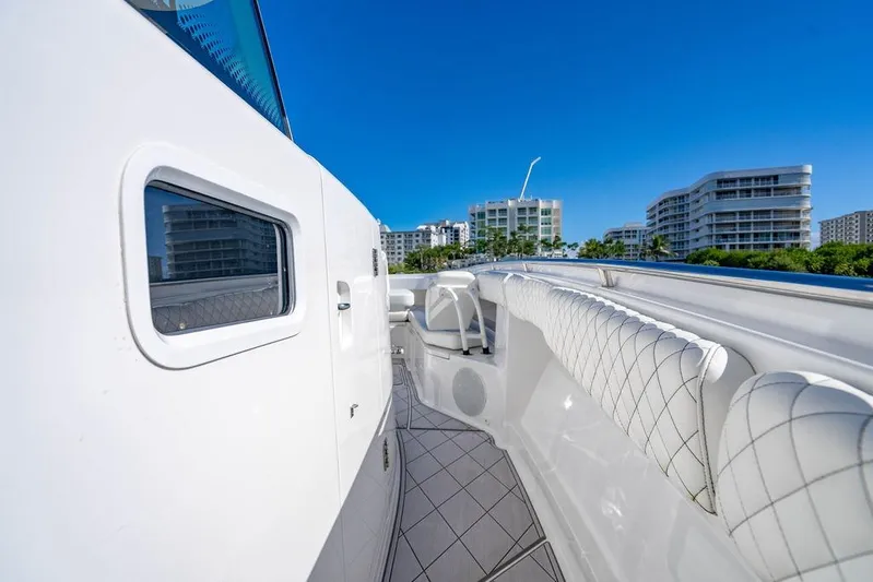  Yacht Photos Pics 2024 HCB 42 Lujo yacht deck with luxurious seating, cityscape in background.