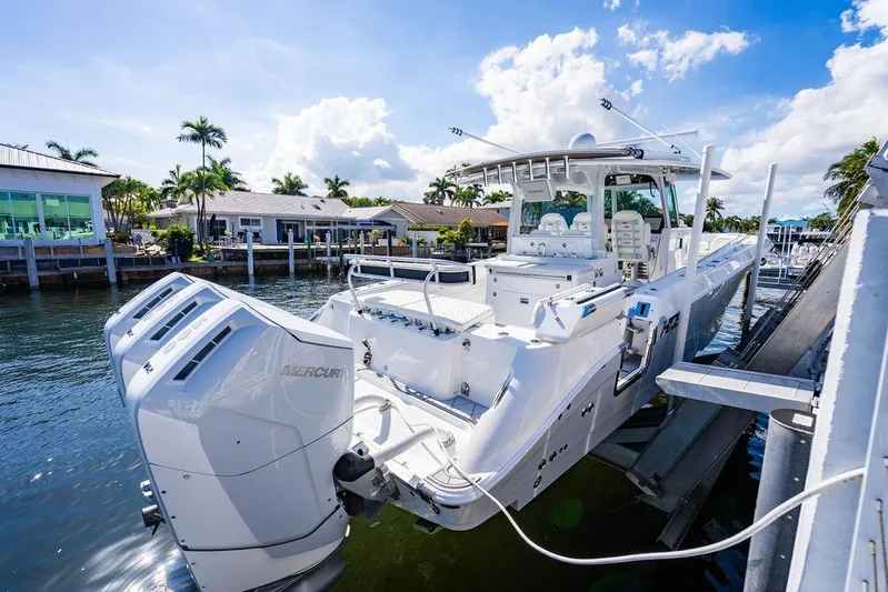  Yacht Photos Pics 2024 HCB 42 Lujo boat docked, featuring powerful Mercury engines, under a sunny sky.