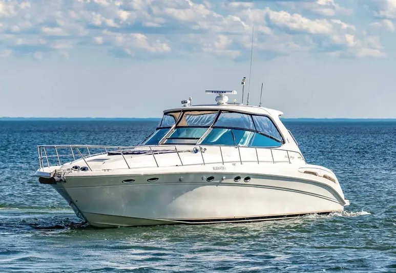  Yacht Photos Pics 2000 Sea Ray 540 Sundancer yacht cruising on open water under a partly cloudy sky.