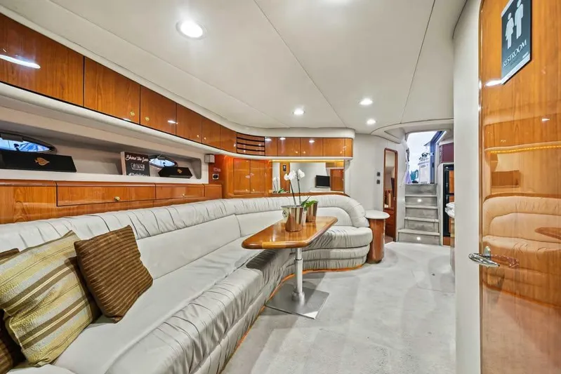  Yacht Photos Pics Luxurious interior of 2000 Sea Ray 540 Sundancer yacht with elegant seating and wooden cabinetry.