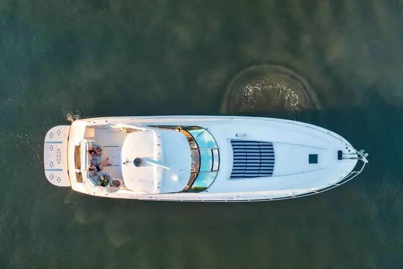  Yacht Photos Pics Aerial view of 2000 Sea Ray 540 Sundancer yacht cruising on calm water.