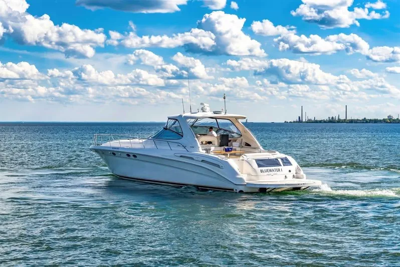  Yacht Photos Pics 2000 Sea Ray 540 Sundancer yacht cruising on a sunny day with blue skies.