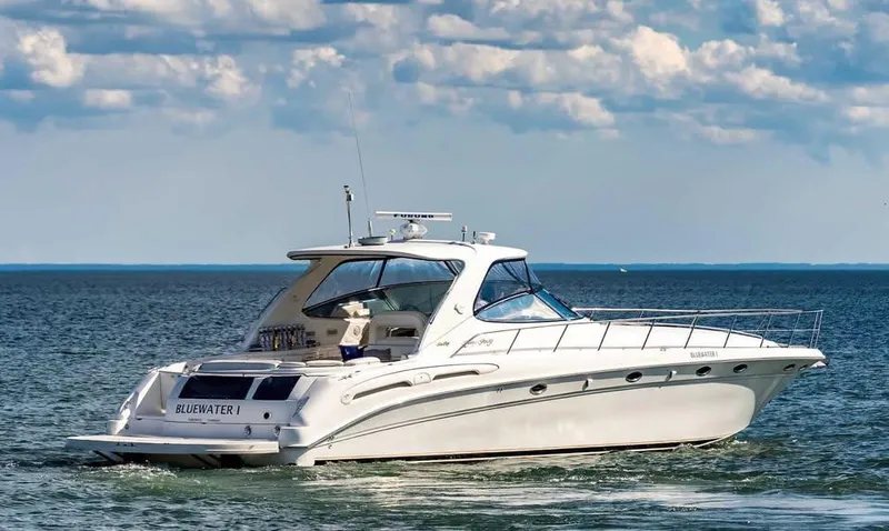  Yacht Photos Pics 2000 Sea Ray 540 Sundancer yacht cruising on open water under a partly cloudy sky.