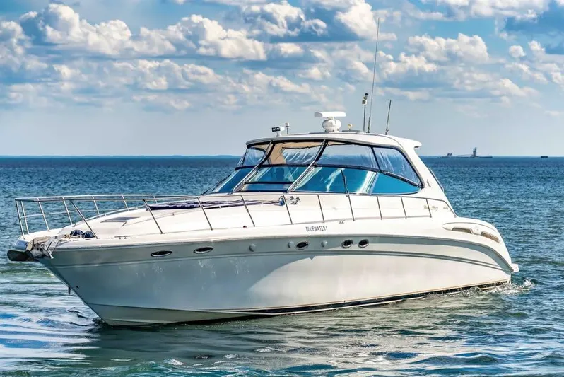  Yacht Photos Pics 2000 Sea Ray 540 Sundancer yacht cruising on a sunny day with blue skies.