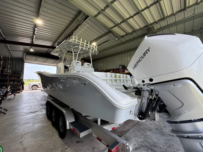  Yacht Photos Pics 2020 Yellowfin 36 Offshore boat in a garage, featuring a Mercury engine.