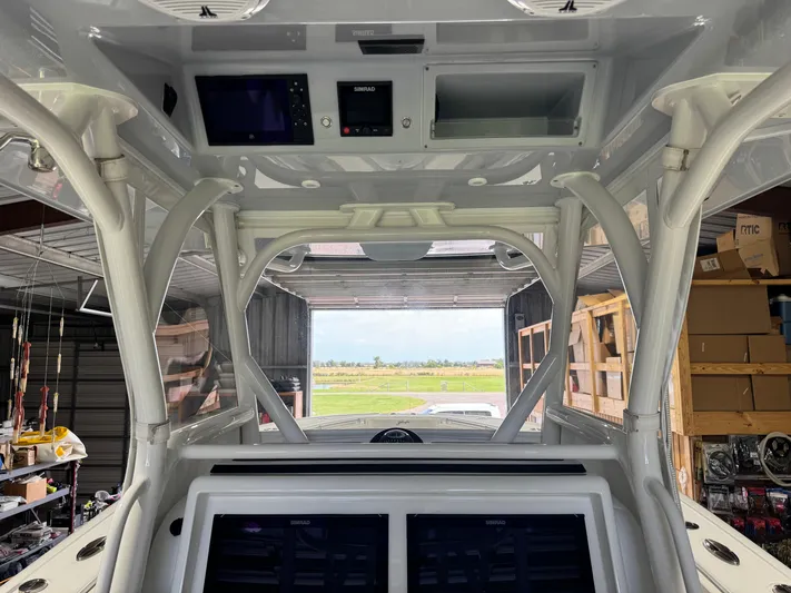  Yacht Photos Pics 2020 Yellowfin 36 Offshore boat interior with advanced navigation equipment in a storage facility.