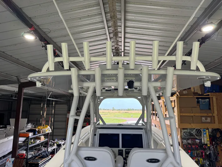  Yacht Photos Pics 2020 Yellowfin 36 Offshore boat in a garage, featuring rod holders and navigation equipment.