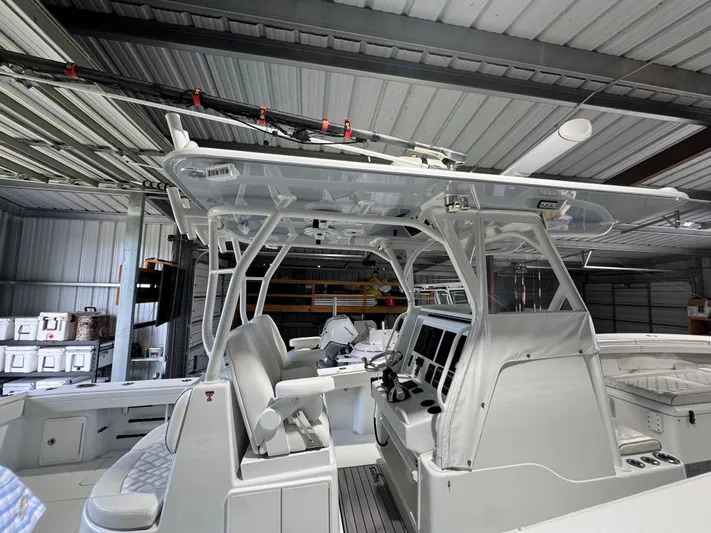  Yacht Photos Pics 2020 Yellowfin 36 Offshore boat interior with modern controls and seating in a storage facility.