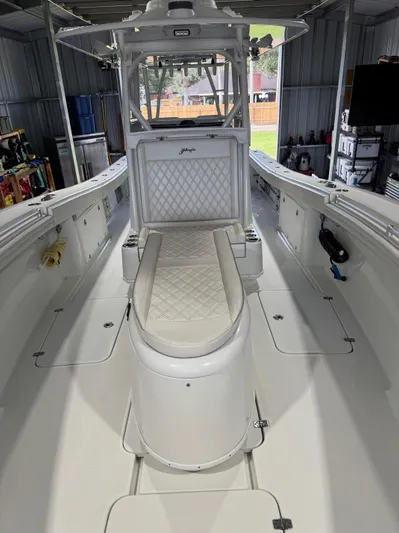  Yacht Photos Pics 2020 Yellowfin 36 Offshore boat interior with cushioned seating and storage compartments.
