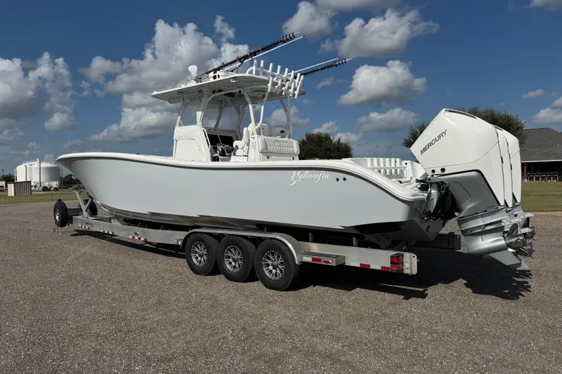  Yacht Photos Pics 2020 Yellowfin 36 Offshore boat on trailer, featuring Mercury engines, under a partly cloudy sky.