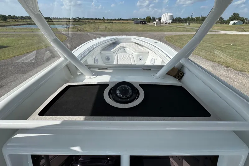  Yacht Photos Pics 2020 Yellowfin 36 Offshore boat interior with compass, docked on grassy area.