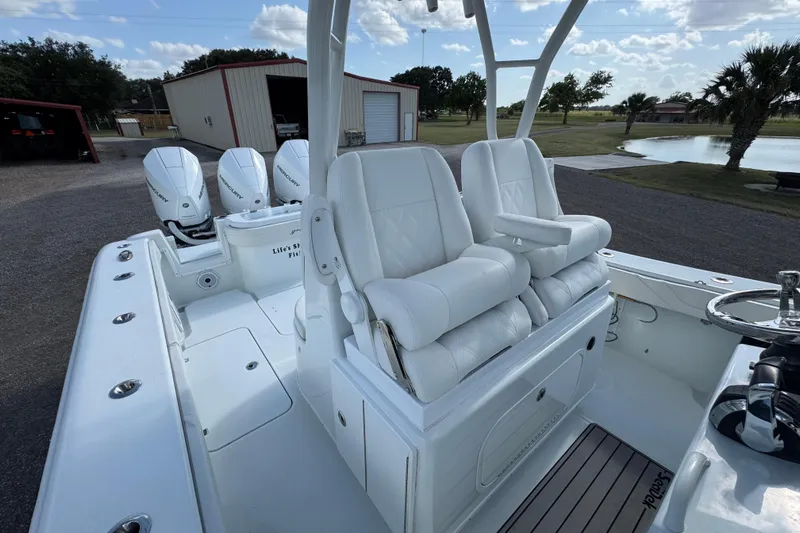  Yacht Photos Pics 2020 Yellowfin 36 Offshore boat with white seating and triple Mercury engines.