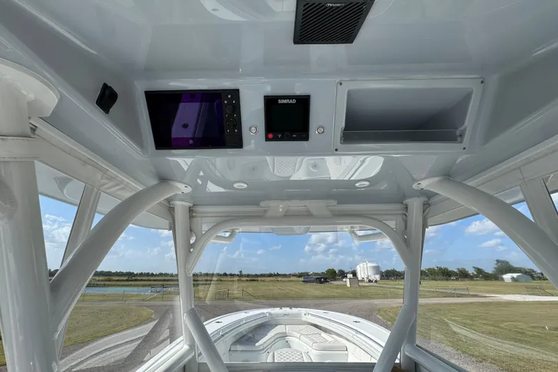  Yacht Photos Pics 2020 Yellowfin 36 Offshore boat interior with navigation equipment and open storage compartment.