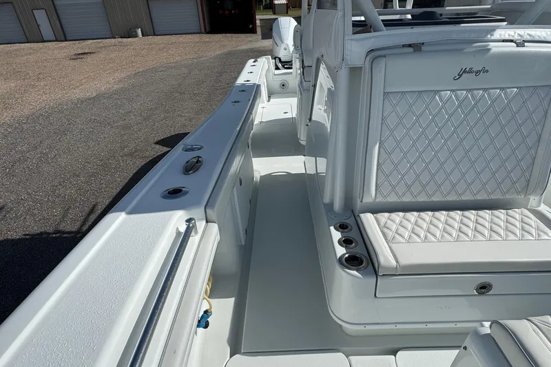  Yacht Photos Pics 2020 Yellowfin 36 Offshore boat interior with white quilted seating and rod holders.