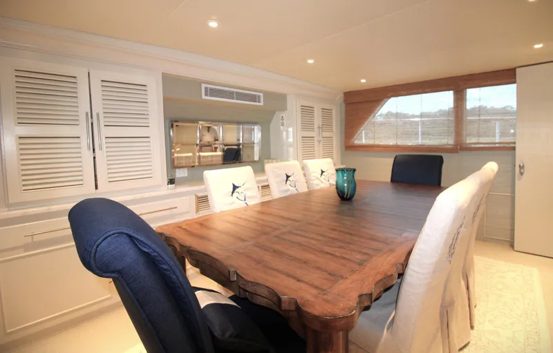 Freedom Yacht Photos Pics Luxurious dining area in 1979 Burger Raised Pilothouse yacht with elegant wooden table.