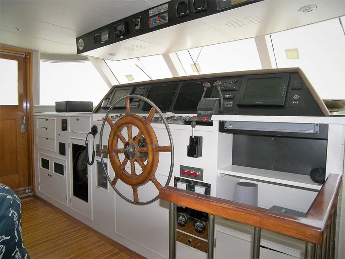 Freedom Yacht Photos Pics 1979 Burger Raised Pilothouse interior with wooden steering wheel and navigation controls.