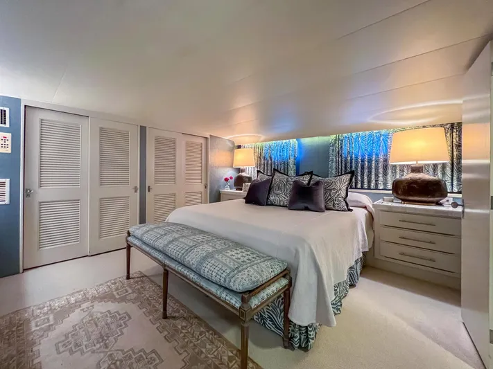 Freedom Yacht Photos Pics Luxurious bedroom interior on 1979 Burger Raised Pilothouse yacht with elegant decor and ambient lighting.