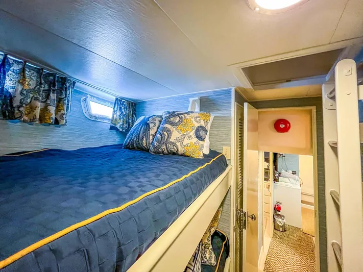 Freedom Yacht Photos Pics Cozy cabin interior of 1979 Burger Raised Pilothouse yacht with bunk bed and nautical decor.