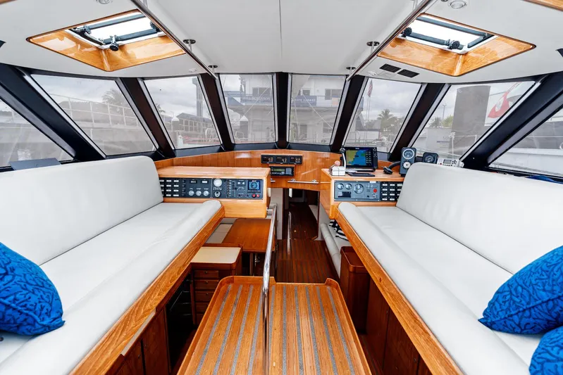 Godspeed Yacht Photos Pics Luxurious 1998 Custom Kelly Archer yacht interior with white seating and wooden accents.