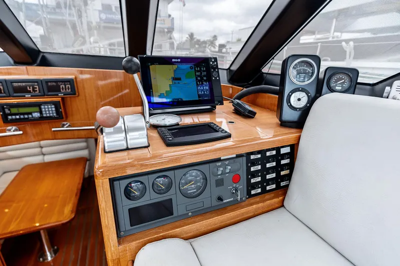Godspeed Yacht Photos Pics Helm of 1998 Custom Kelly Archer yacht with navigation equipment and wooden dashboard.