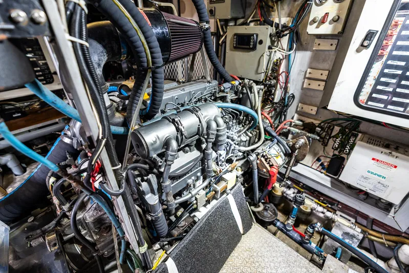 Godspeed Yacht Photos Pics Engine room of a 1998 Custom Kelly Archer boat, showcasing complex machinery and wiring.