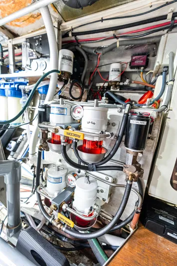 Godspeed Yacht Photos Pics Engine room of a 1998 Custom Kelly Archer boat, showcasing complex piping and filtration systems.