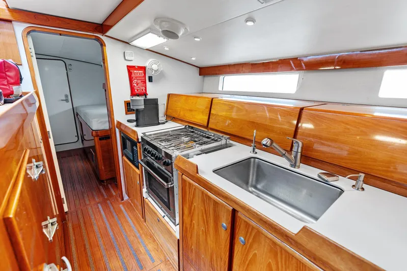 Godspeed Yacht Photos Pics Luxurious 1998 Custom Kelly Archer yacht kitchen with wood cabinetry and modern appliances.