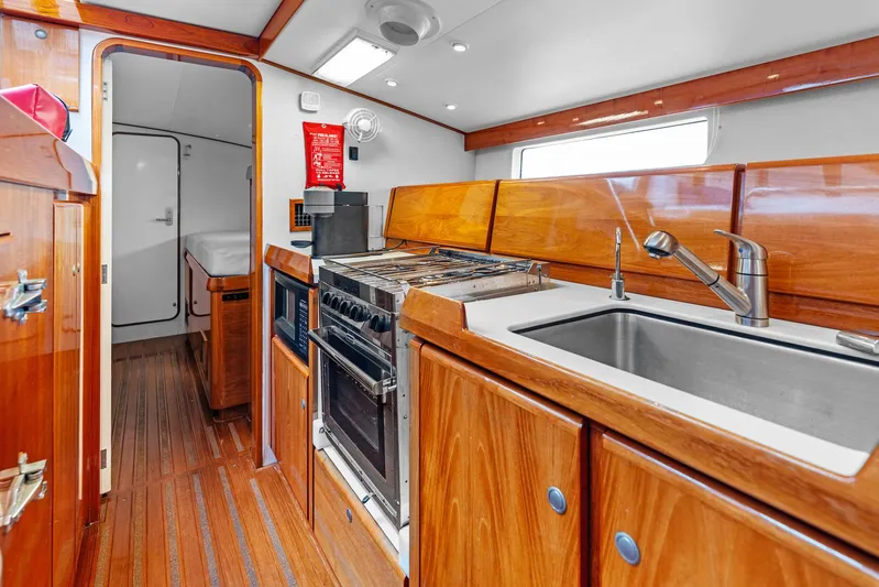 Godspeed Yacht Photos Pics Luxurious wooden yacht kitchen interior with modern appliances, Custom Kelly Archer 1998 model.