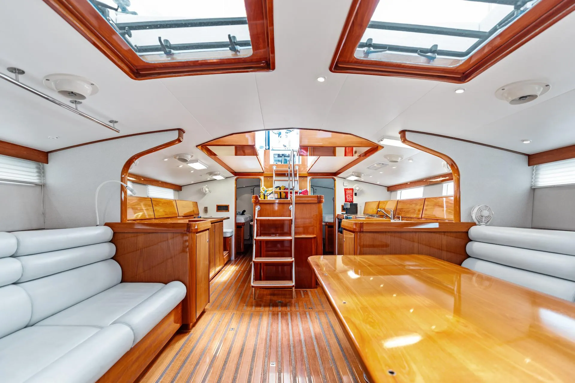 Luxurious interior of 1998 Custom Kelly Archer yacht with wooden finishes and skylights.