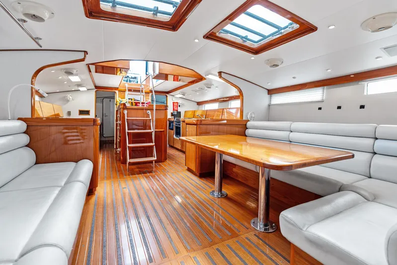 Godspeed Yacht Photos Pics Luxurious 1998 Custom Kelly Archer yacht interior with wooden flooring and plush seating.