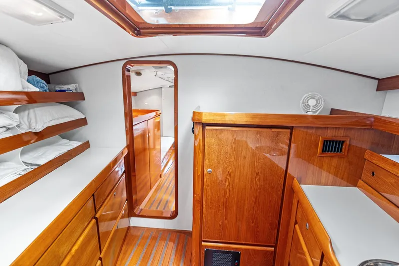 Godspeed Yacht Photos Pics Luxurious wooden interior of 1998 Custom Kelly Archer yacht cabin with storage and bedding.