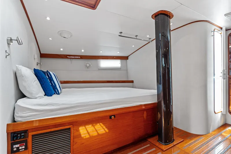 Godspeed Yacht Photos Pics Luxurious cabin interior of 1998 Custom Kelly Archer yacht with wooden accents and cozy bedding.