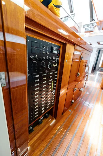 Godspeed Yacht Photos Pics Electrical control panel on a 1998 Custom Kelly Archer yacht with polished wooden interior.