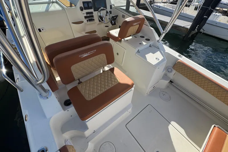  Yacht Photos Pics 2011 Hydra-Sports 3000 VX boat interior with cushioned seating and control panel.