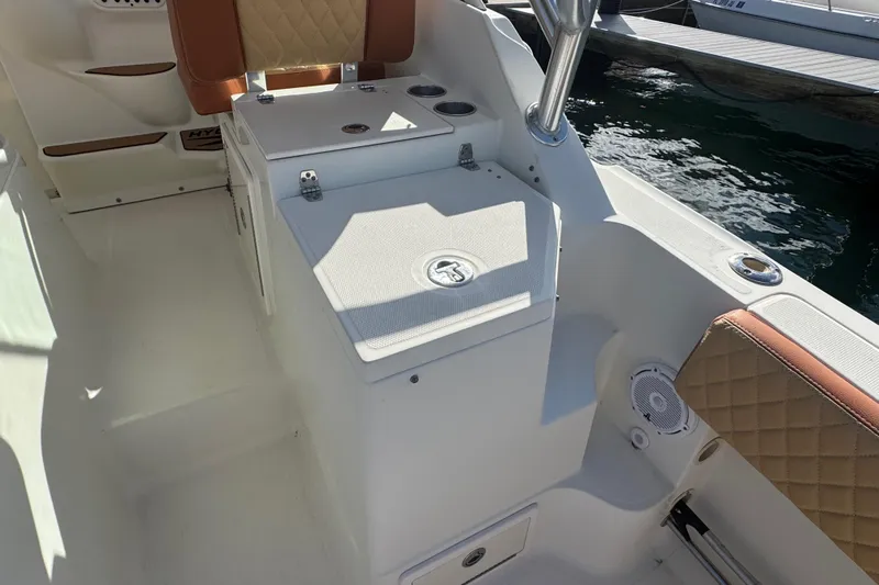  Yacht Photos Pics 2011 Hydra-Sports 3000 VX boat interior with seating and storage, docked by the water.